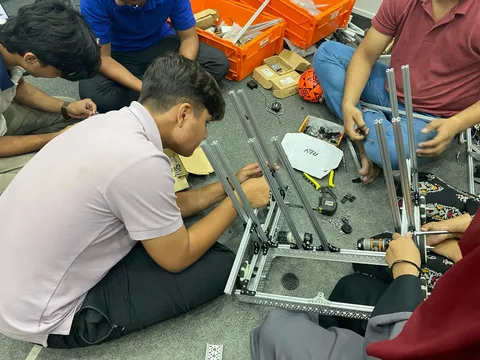 Students collaborating on a competition robot prototype