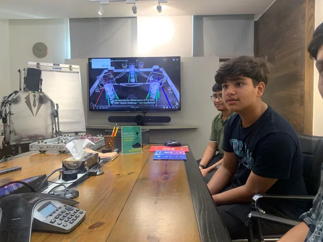 Students reviewing a competition robot design
