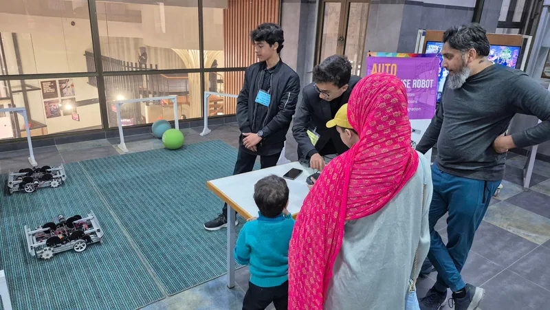 Students taking part in a guided school robotics workshop